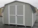 Pine Creek 10x12 HD Mini Barn with Light Gray walls, White trim and White shutters, and Charcoal shingles